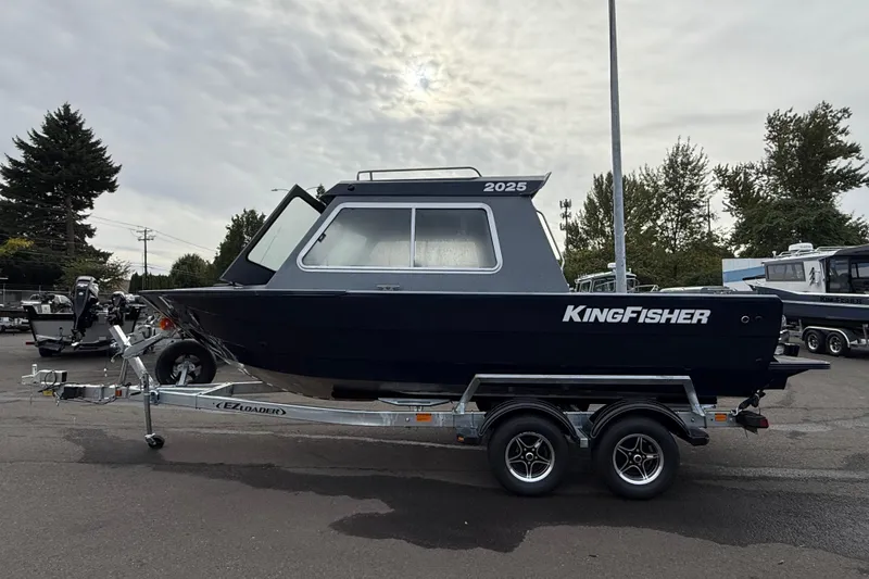 Slide: The Image of KingFisher 2025 Escape HTT boat on trailer, parked outdoors, overcast sky. - 5