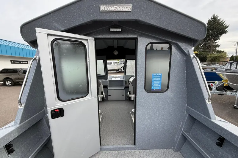 Slide: The Image of 2026 KingFisher 2025 Escape HTT boat interior view with open cabin door. - 9