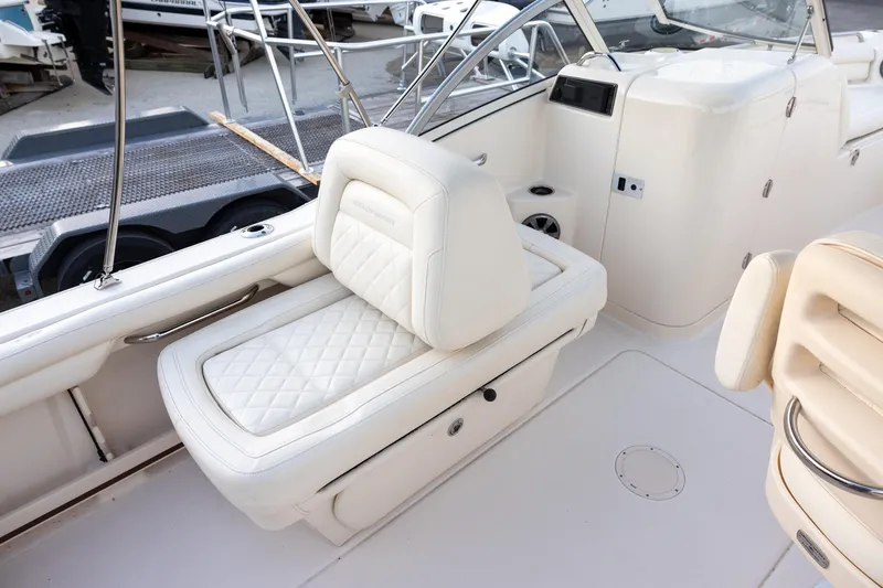 Slide: The Image of 2021 Grady-White Freedom 215 boat interior with white cushioned seating. - 5