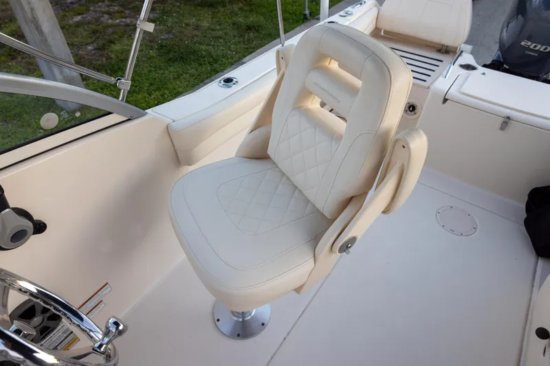 Slide: The Image of 2021 Grady-White Freedom 215 boat interior with luxurious seating and steering wheel. - 9