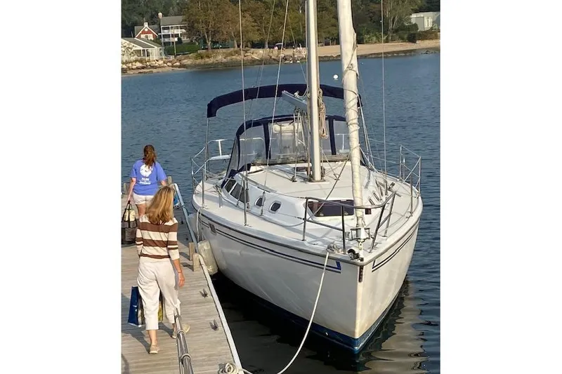 The Image of 2006 Catalina 320 MkII sailboat docked with people boarding. - 0