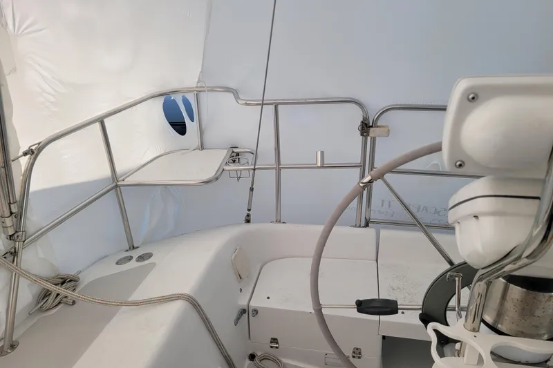 Slide: The Image of Interior view of a 2006 Catalina 320 sailboat cockpit with steering wheel and seating. - 10