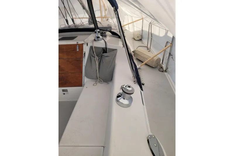Slide: The Image of 2006 Catalina 320 sailboat deck with winch and storage compartments. - 12
