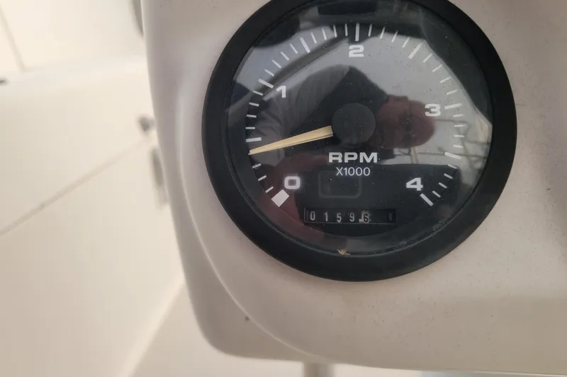 Slide: The Image of Close-up of a Catalina 320 tachometer showing 1596 RPM, model year 2006. - 17