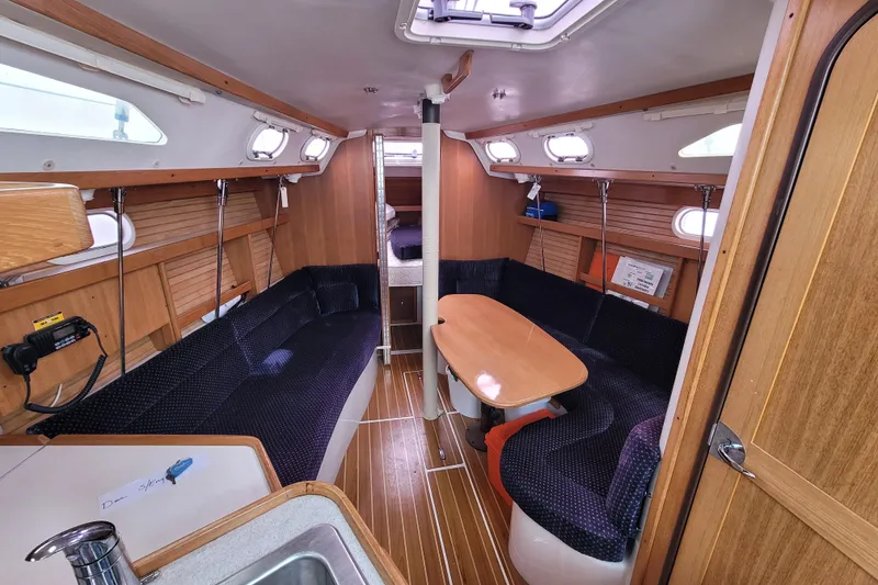 Slide: The Image of Interior of a 2006 Catalina 320 sailboat with cozy seating and wooden finishes. - 20