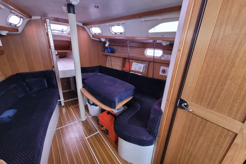 Slide: The Image of Interior of a 2006 Catalina 320 sailboat with cozy seating and wooden finishes. - 21