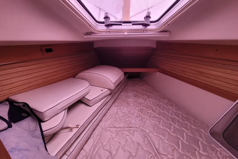 Slide: The Image of Interior cabin of a 2006 Catalina 320 sailboat with cushions and wood paneling. - 24