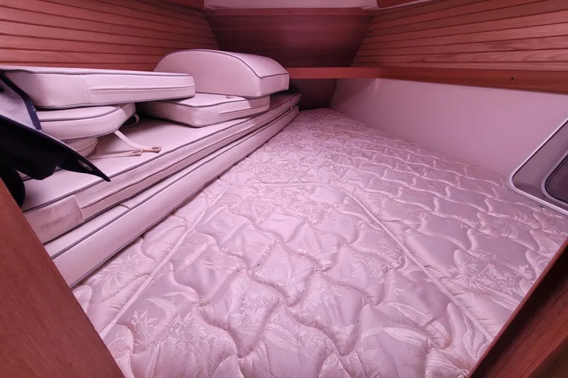 Slide: The Image of Interior cabin of a 2006 Catalina 320 sailboat with cushions and mattress. - 25
