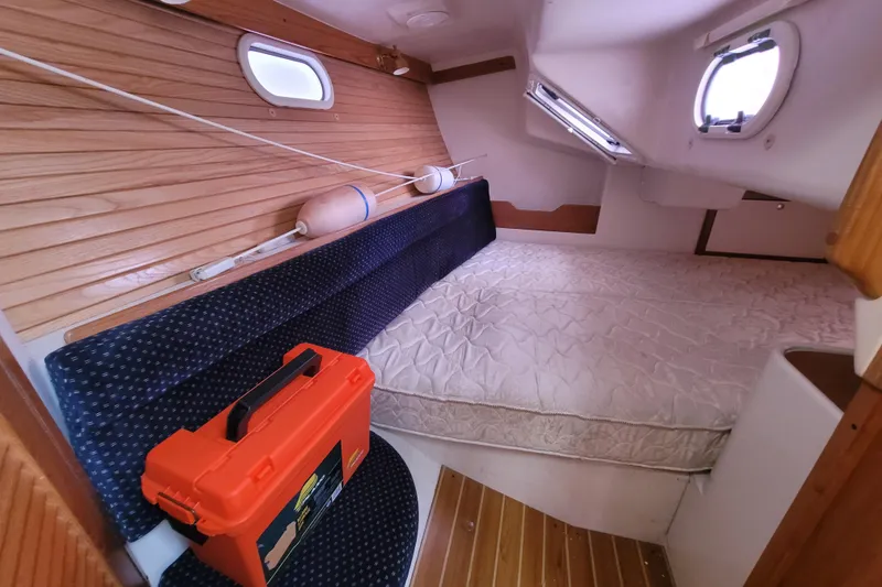 Slide: The Image of Cozy cabin interior of 2006 Catalina 320 sailboat with bed and storage. - 30