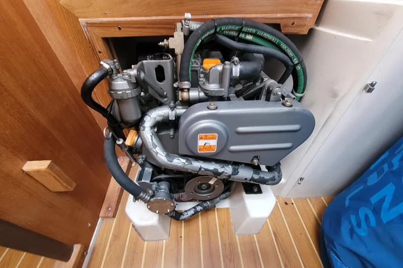 Slide: The Image of Engine compartment of a 2006 Catalina 320 sailboat, showcasing mechanical components. - 33