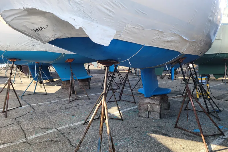 Slide: The Image of Catalina 320 sailboat from 2006 on stands, hull wrapped and supported. - 34