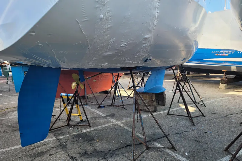 Slide: The Image of Catalina 320 sailboat from 2006 on stands, showing keel and propeller. - 36