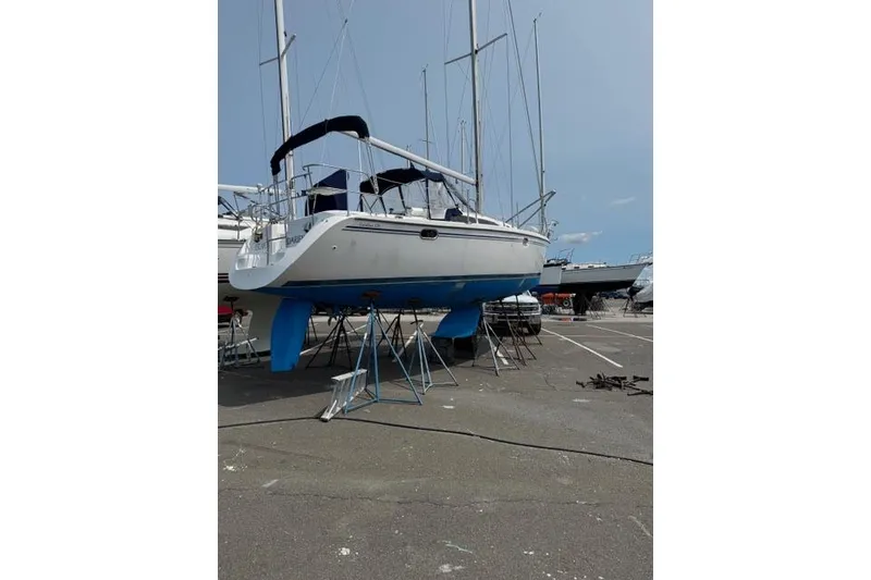Slide: The Image of Catalina 320 sailboat from 2006 on stands in a boatyard. - 8