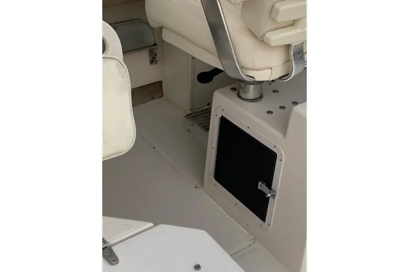 Slide: The Image of Interior of 1992 Grady-White Dolphin 251 boat, featuring seating and storage compartment. - 3