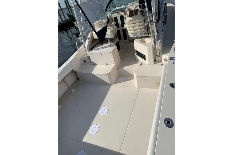 Slide: The Image of 1992 Grady-White Dolphin 251 boat interior with seating and steering console. - 5