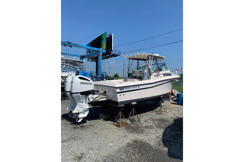 Slide: The Image of 1992 Grady-White Dolphin 251 boat with Honda outboard motor on display. - 8