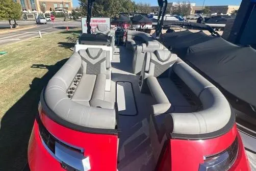 Slide: The Image of 2023 Montara Naxos boat with spacious seating, parked outdoors on a sunny day. - 2