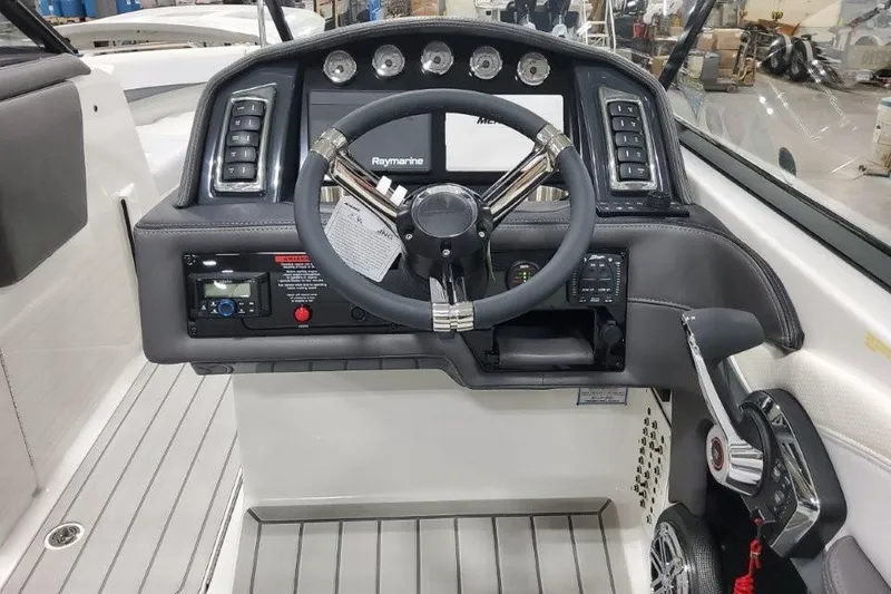 Slide: The Image of Steering console of a 2026 Formula 270 Bowrider with modern controls and Raymarine display. - 13