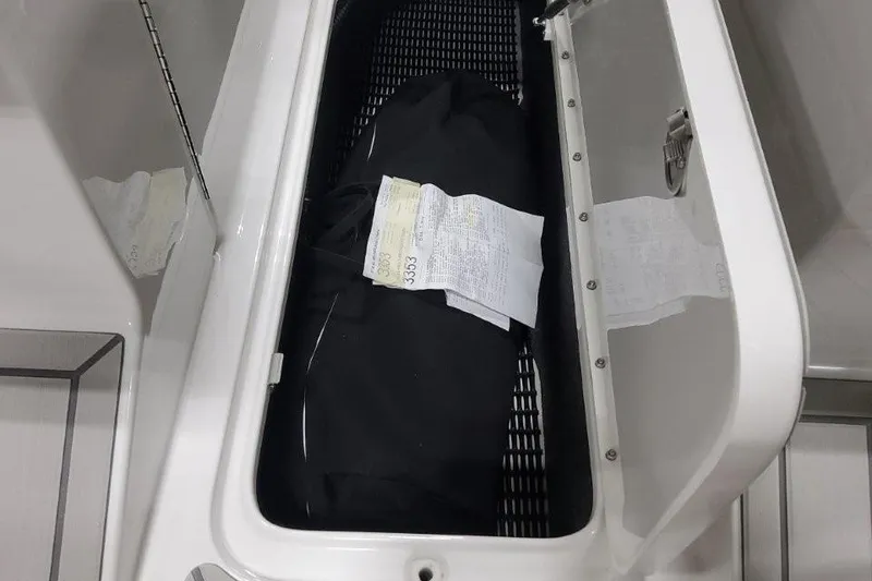 Slide: The Image of Open storage compartment in 2026 Formula 270 Bowrider boat with documents inside. - 19