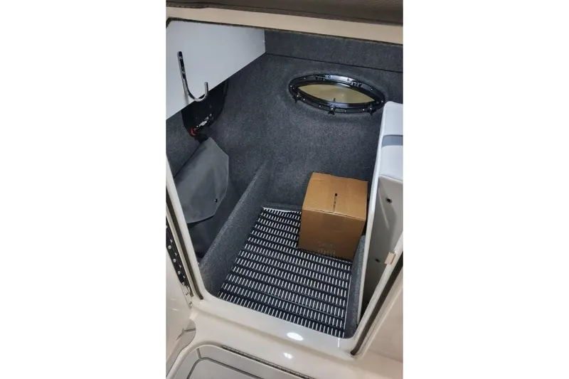 Slide: The Image of Interior storage compartment of 2026 Formula 270 Bowrider boat with a cardboard box. - 20