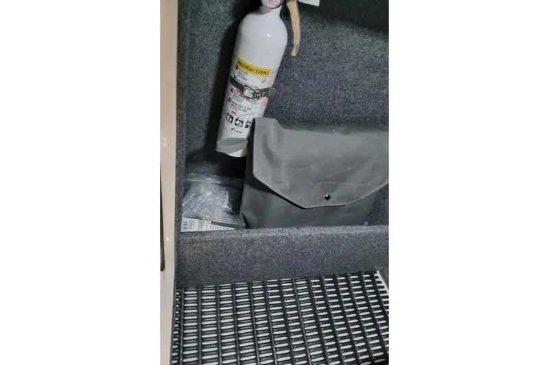 Slide: The Image of Storage compartment in a 2026 Formula 270 Bowrider with fire extinguisher and bag. - 21