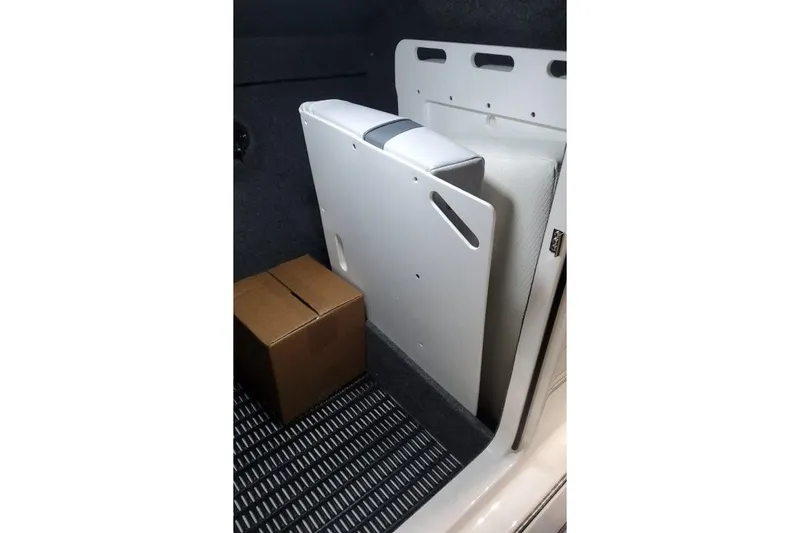 Slide: The Image of Storage compartment in a 2026 Formula 270 Bowrider boat with a cardboard box. - 22