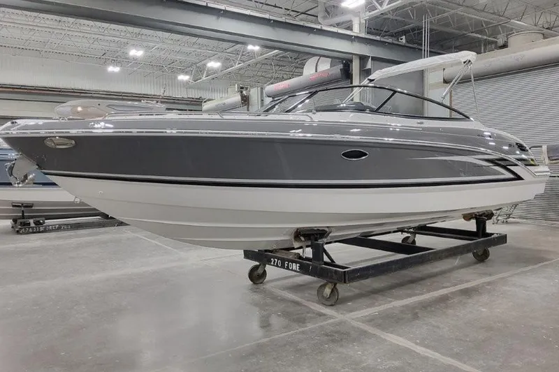 Slide: The Image of 2026 Formula 270 Bowrider boat in a showroom, sleek gray design on a trailer. - 3