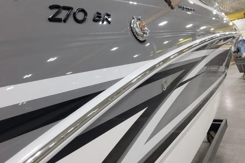 Slide: The Image of 2026 Formula 270 Bowrider boat with sleek gray and white design in a showroom. - 4