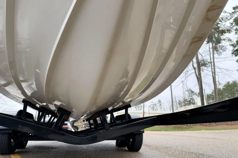 Slide: The Image of Underside view of a 2019 Cobalt R5 Surf boat on a trailer. - 16
