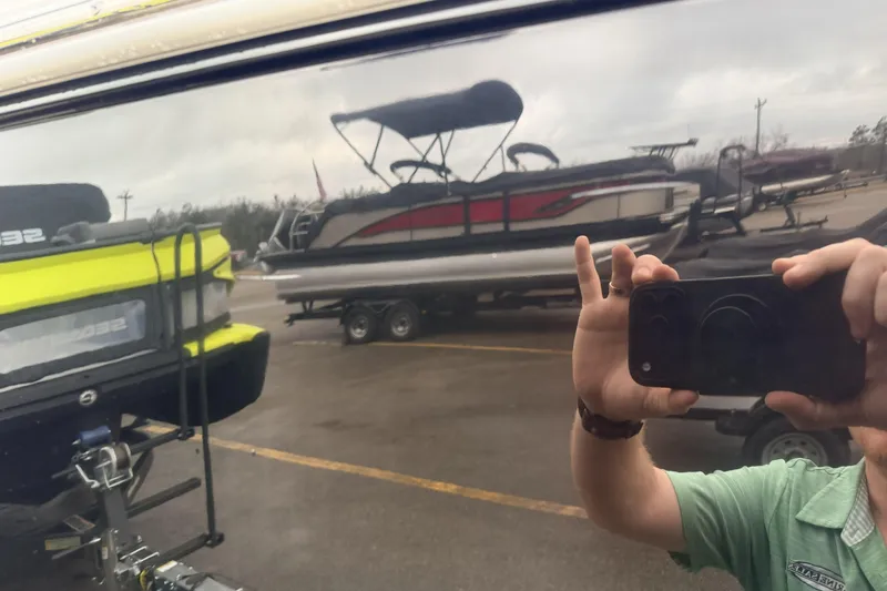 Slide: The Image of Reflection of a 2019 Cobalt R5 Surf boat with a person taking a photo. - 17