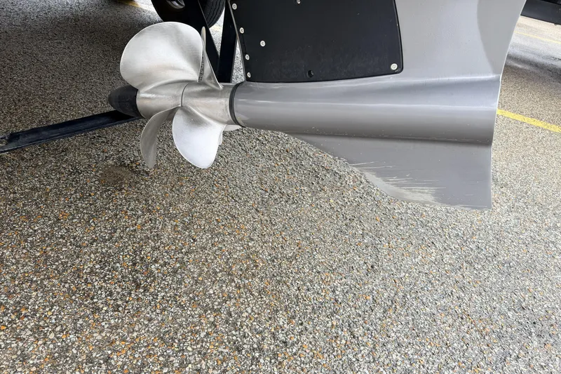 Slide: The Image of Close-up of a 2019 Cobalt R5 Surf boat propeller on a textured surface. - 19