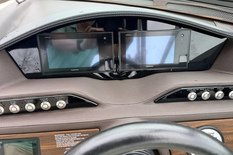 Slide: The Image of Dashboard of a 2019 Cobalt R5 Surf boat with Garmin displays and control buttons. - 25