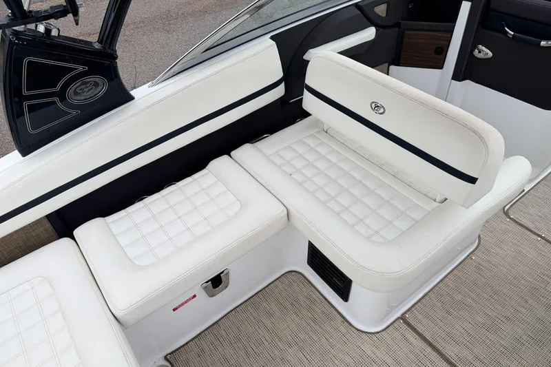 Slide: The Image of 2019 Cobalt R5 Surf boat interior with white cushioned seating and sleek design. - 28