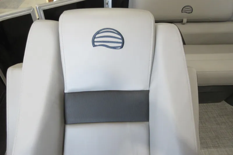 Slide: The Image of 2026 Sun Tracker Party Barge 20 DLX seat with logo, featuring gray and white upholstery. - 10