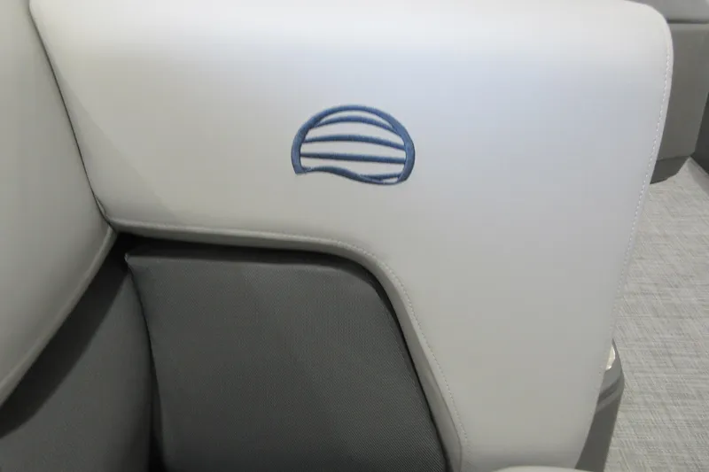 Slide: The Image of 2026 Sun Tracker Party Barge 20 DLX interior with logo on light gray upholstery. - 11