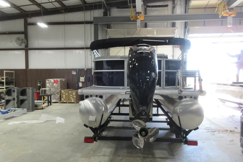 Slide: The Image of 2026 Sun Tracker Party Barge 20 DLX pontoon boat in a warehouse setting. - 4