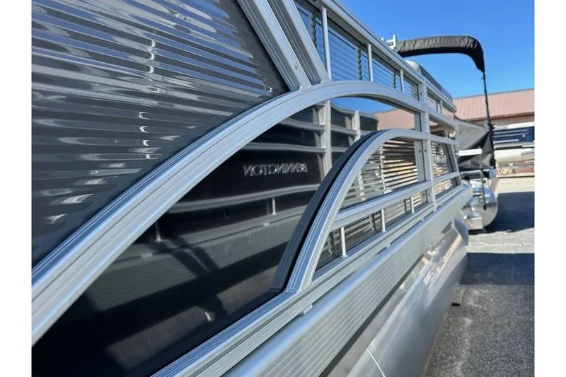 Slide: The Image of 2026 Bennington 20 SSR Quad Bench pontoon boat with Yamaha 90Hp engine, side view. - 20