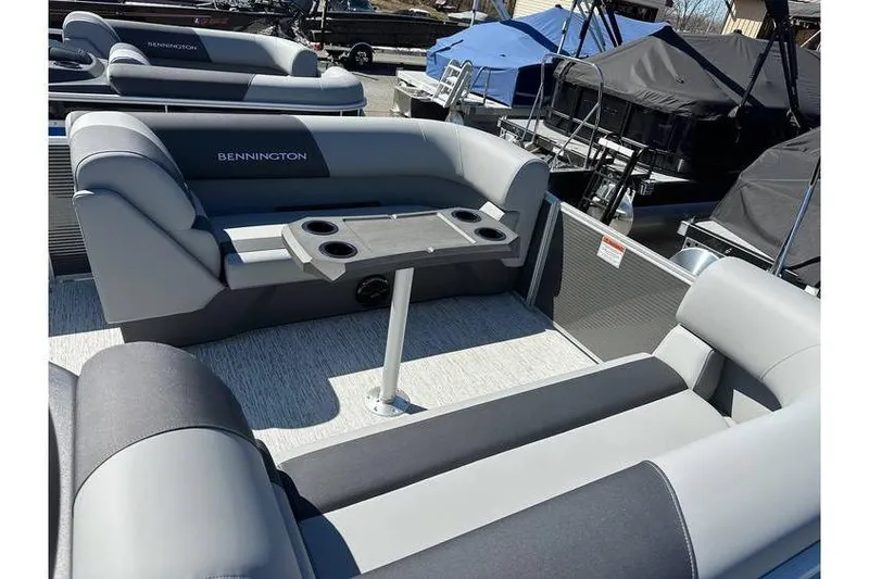 Slide: The Image of 2026 Bennington 20 SSR Quad Bench pontoon boat with Yamaha 90Hp engine, featuring spacious seating. - 6