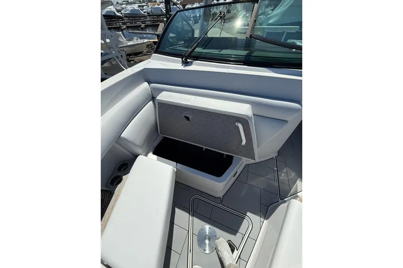 Slide: The Image of 2023 Aviara AV32 I/O boat interior with open storage compartment and seating area. - 14