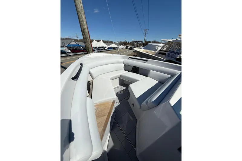 Slide: The Image of 2023 Aviara AV32 I/O boat interior with white seating and wood accents. - 16