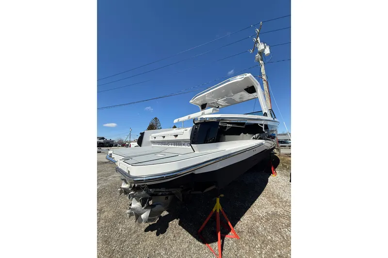 Slide: The Image of 2023 Aviara AV32 I/O boat displayed outdoors under clear blue sky. - 2