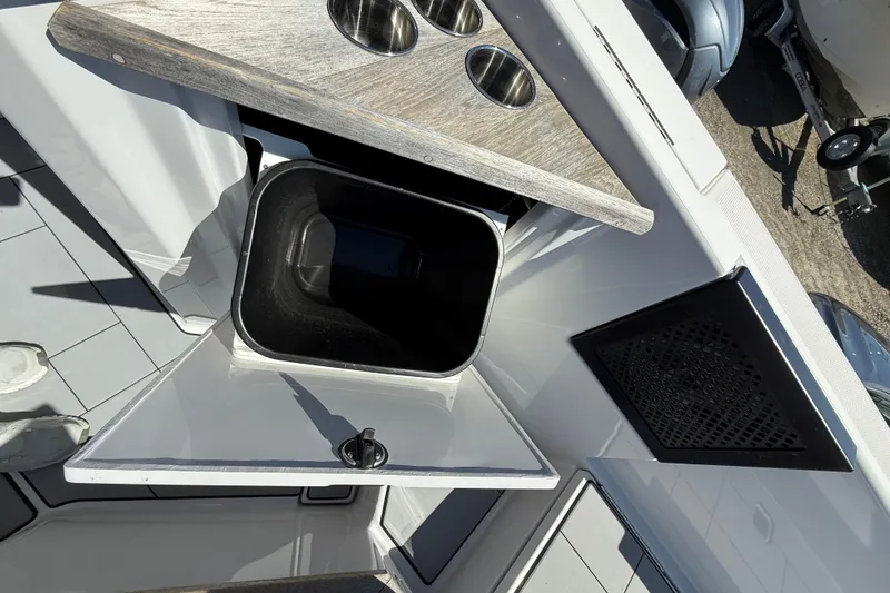 Slide: The Image of 2023 Aviara AV32 I/O boat interior with storage compartment and cup holders. - 23
