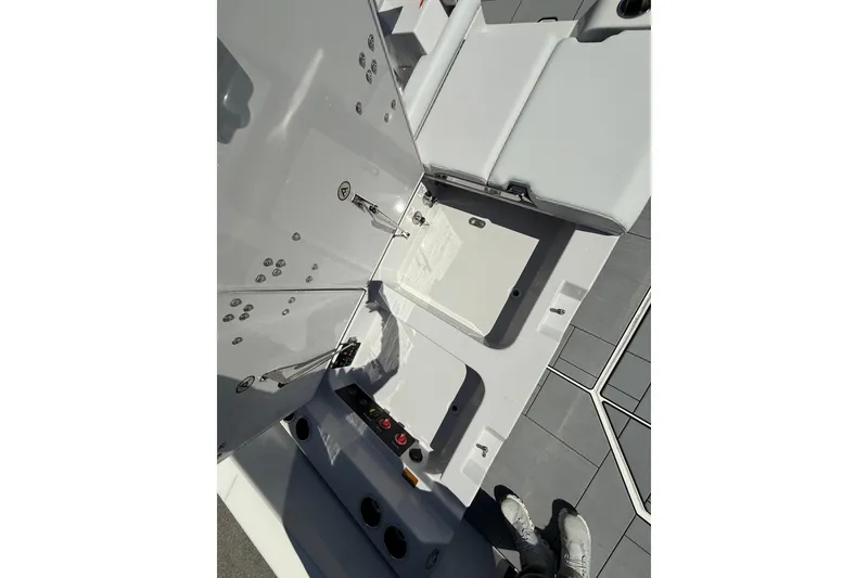 Slide: The Image of 2023 Aviara AV32 I/O boat interior showing storage compartments and seating area. - 8