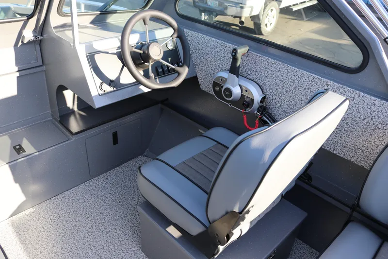 Slide: The Image of 2026 Alumaweld Stryker 220 boat interior with steering wheel and control panel. - 11