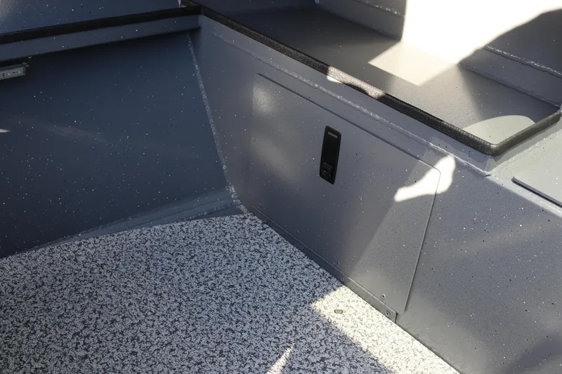 Slide: The Image of Interior of 2026 Alumaweld Stryker 220 boat with speckled flooring and storage compartment. - 21