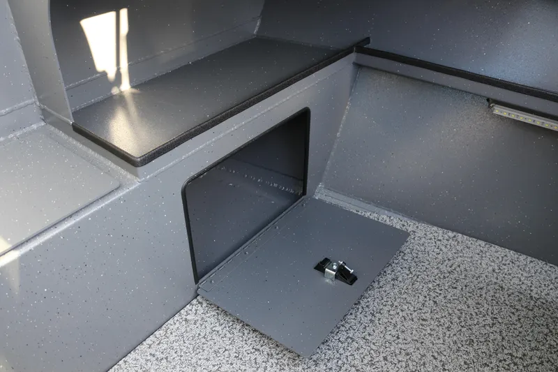 Slide: The Image of Interior storage compartment of 2026 Alumaweld Stryker 220 boat, featuring sleek gray design. - 23