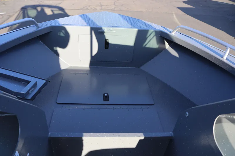 Slide: The Image of 2026 Alumaweld Stryker 220 boat interior with storage compartment and metal railings. - 24
