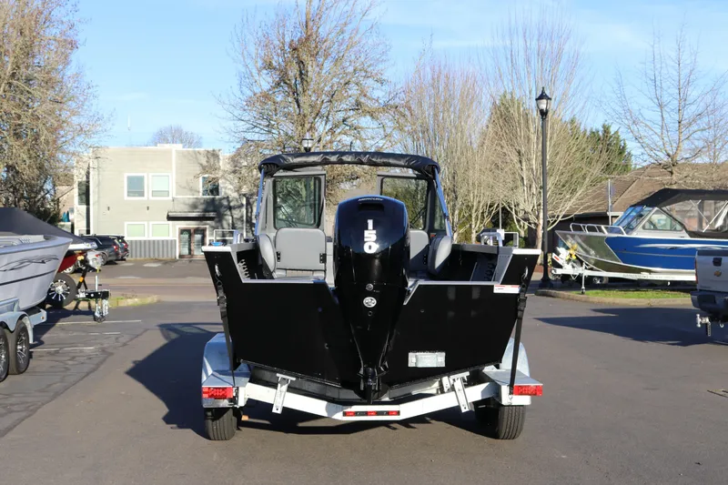 Slide: The Image of 2026 Alumaweld Stryker 220 boat on trailer, rear view with 150 HP engine. - 3
