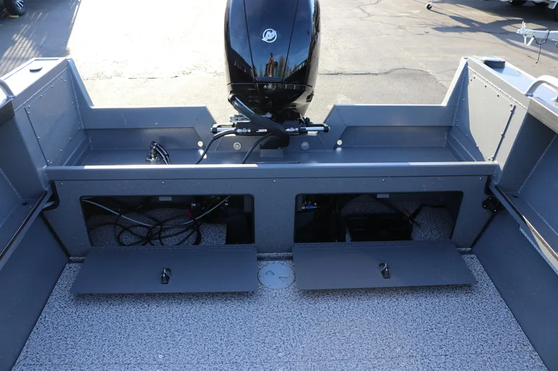 Slide: The Image of 2026 Alumaweld Stryker 220 boat interior with open storage compartments and motor. - 35