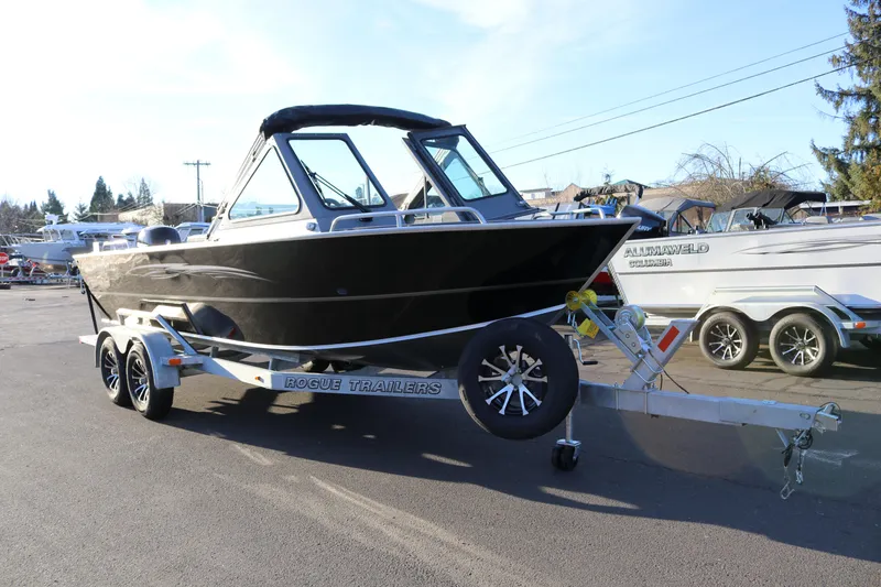 Slide: The Image of 2026 Alumaweld Stryker 220 boat on Rogue trailer in outdoor setting. - 5